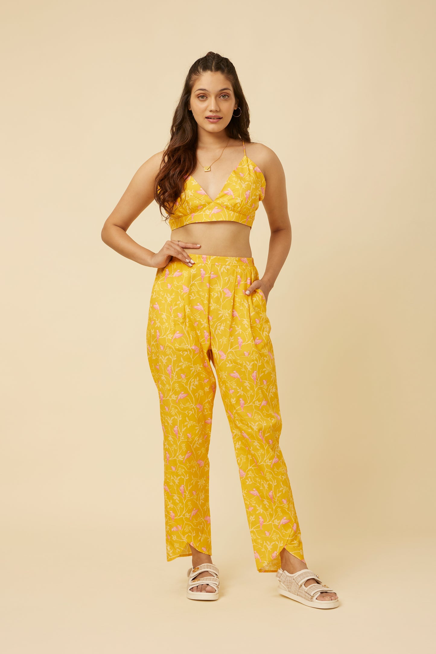 Side profile of the Peela Sunshine Pants highlighting the modern twist of the tulip hemline and the practical side pockets for added convenience