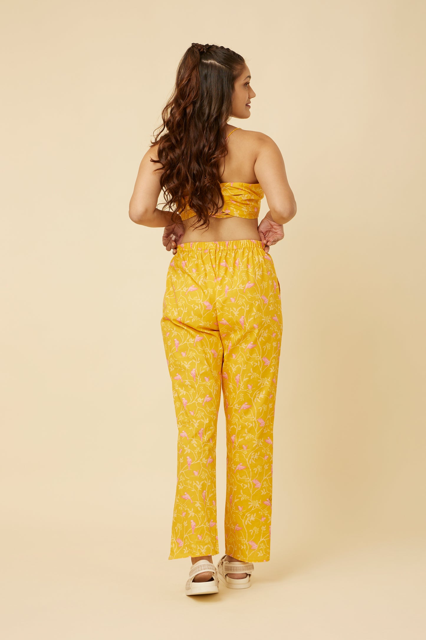 Close-up of the Peela Sunshine Pants' tulip hemline, showcasing the modern twist on the classic silhouette for a fashionable and cheerful ensemble