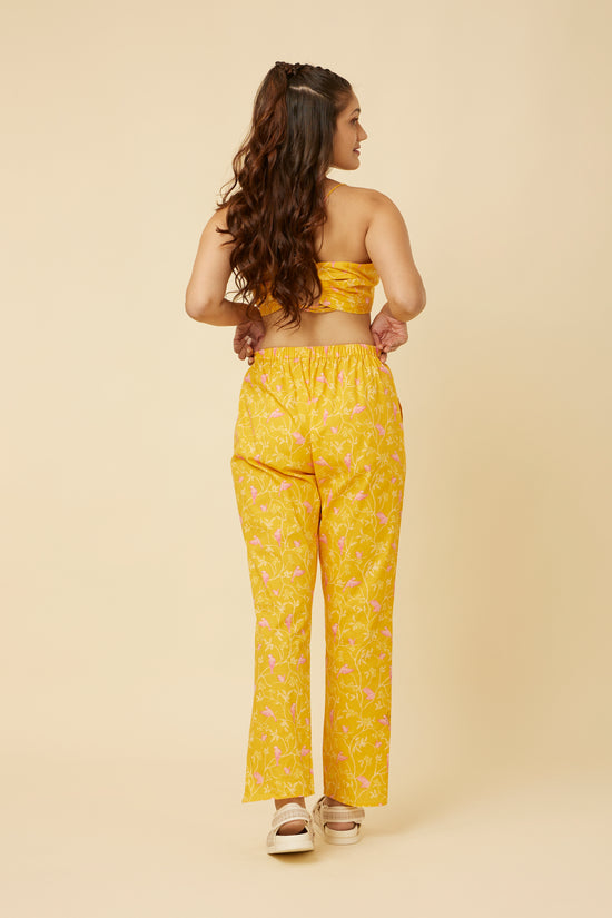 Close-up of the Peela Sunshine Pants' tulip hemline, showcasing the modern twist on the classic silhouette for a fashionable and cheerful ensemble