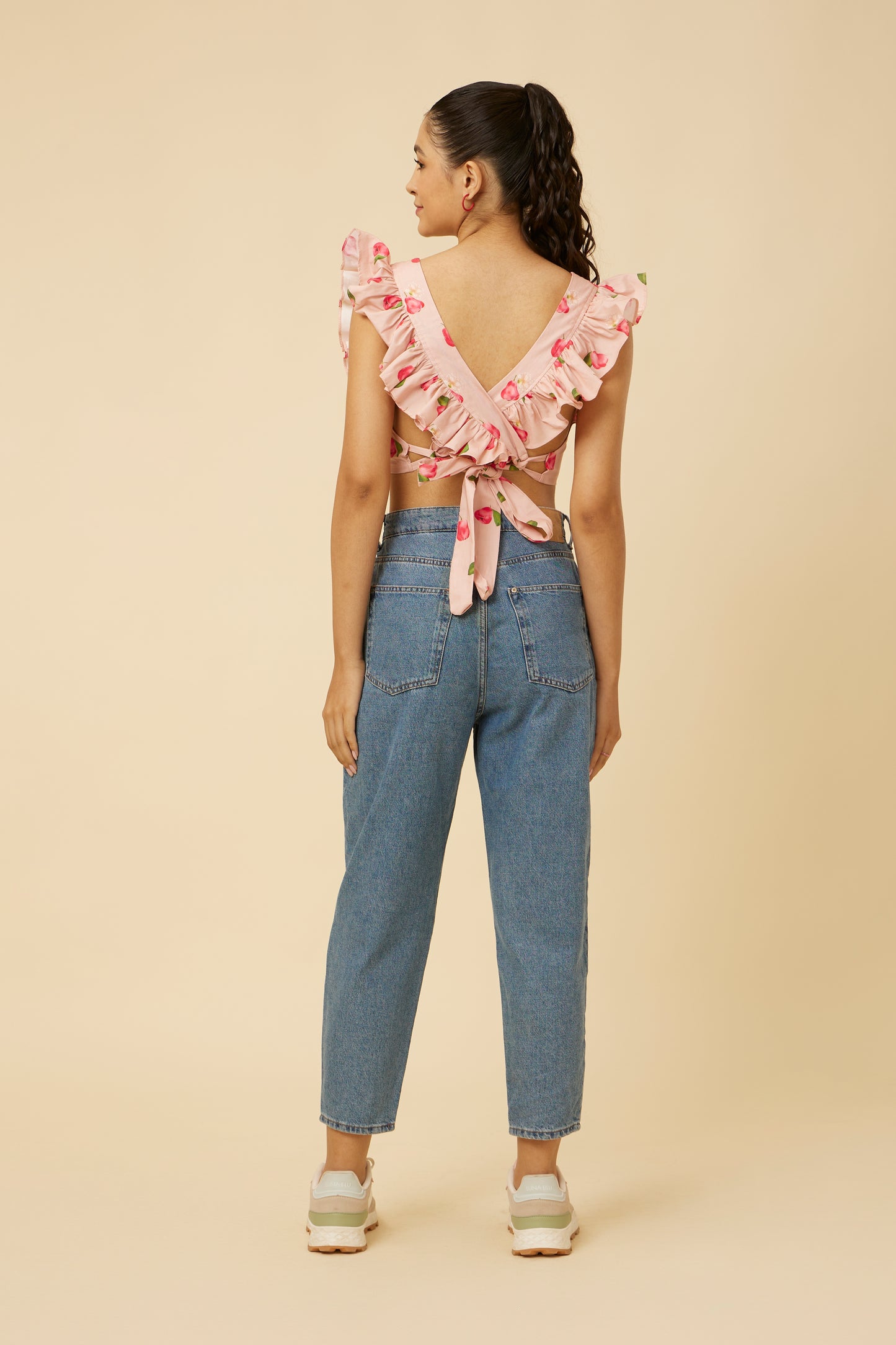 Back view of the Rose Apple Frill Crop Top, showcasing the unique overlapping back frill with tie-able ends at the wais