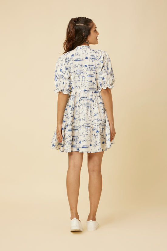 Rear view of the Homeland Print Dress showing the tiered design and the elastic endings of the balloon sleeves, offering a casual yet chic look