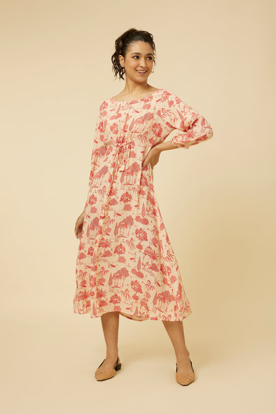 Model posing in Jaipur Rani pink printed dress with A-line silhouette, center tie, and three-quarter sleeves.