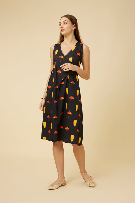 Three-quarter view of a model wearing the Spree Black Dress, accentuating the sleeveless cut and cultural motifs, suitable for various occasions