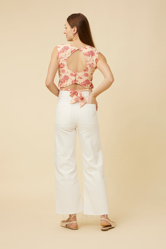 Rear view of the 'Jaipur Rani' crop top, emphasizing the back tie feature with round cut-out, set against a complementary pair of white pants
